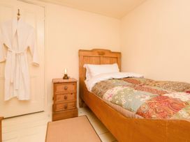 A bedroom with a bed and bedside table at Ladye Park in Liskeard