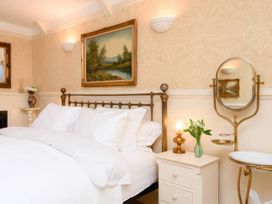 A bedroom with a bed and nightstand at Ladye Park in Liskeard