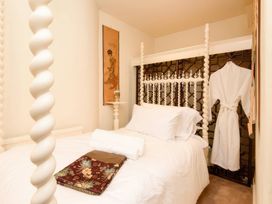 A bedroom with a bed and wall art at Ladye Park in Liskeard