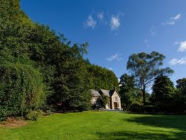 A house in a garden with trees and grass at Ladye Park in Liskeard