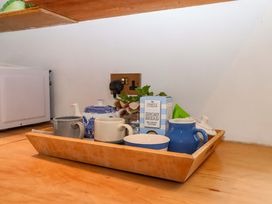 A kitchen counter with cups and a teapot on a tray at Old Sunday School in Welcombe near Kilkhampton