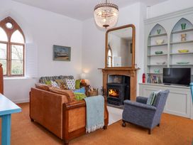 A living room with a sofa and armchair at the Old Sunday School Welcombe near Kilkhampton