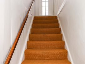 A staircase with a handrail and window at Old Sunday School in Welcombe near Kilkhampton