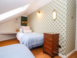A bedroom with a bed and nightstand at Old Sunday School Welcombe near Kilkhampton