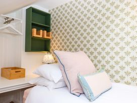 A bedroom with a bed and pillows at Old Sunday School in Welcombe near Kilkhampton
