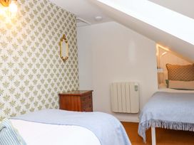 A bedroom with a bed and nightstand at The Old Sunday School in Welcombe near Kilkhampton