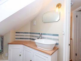 A bathroom with a sink and mirror at The Old Sunday School in Welcombe near Kilkhampton