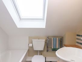 A bathroom with a toilet, bathtub, and sink at The Old Sunday School in Welcombe near Kilkhampton