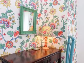 A table with a lamp and mirror at Old Sunday School, Welcombe near Kilkhampton