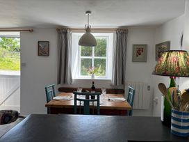 A dining room with a table and chairs at The Old Sunday School in Welcombe