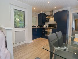 A kitchen with a dining table and chairs at Evermore Lodge, 48 Calgarth Park, White Cross Bay, Windermere