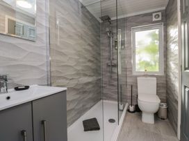 A bathroom with a sink, toilet, and shower at Evermore Lodge, 48 Calgarth Park, White Cross Bay, Windermere