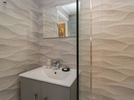 A bathroom with sink and mirror at Evermore Lodge, 48 Calgarth Park, White Cross Bay, Windermere