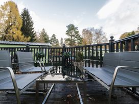 A seating area with chairs and a table at Evermore Lodge, 48 Calgarth Park, White Cross Bay, Windermere