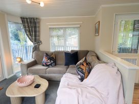 A living room with a sofa and coffee table at Evermore Lodge 48 Calgarth Park, White Cross Bay, Windermere