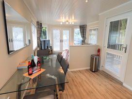 A dining room with a table and chairs at Evermore Lodge, 48 Calgarth Park, White Cross Bay, Windermere