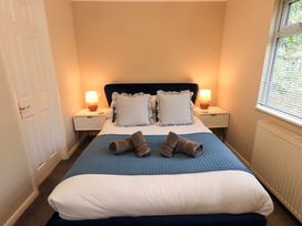 A bedroom with a bed and bedside tables at Evermore Lodge 48 Calgarth Park, White Cross Bay, Windermere