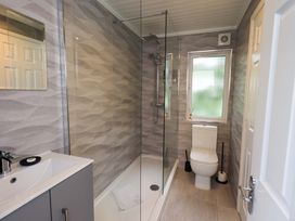 A bathroom with a shower and sink at Evermore Lodge, 48 Calgarth Park, White Cross Bay, Windermere