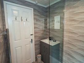 A bathroom with a sink and shower at Evermore Lodge 48 Calgarth Park, White Cross Bay, Windermere