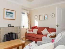 A living room with a red sofa and coffee table at Woodbury in Teignmouth