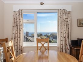 A dining room with a view of the sea at Woodbury Teignmouth