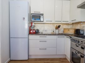A kitchen with appliances and storage at Woodbury in Teignmouth