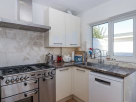 A kitchen with a stove and sink at Woodbury in Teignmouth