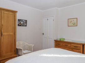 A bedroom with a wardrobe and a chair at Woodbury in Teignmouth