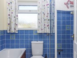 A bathroom with a bathtub and toilet at Woodbury in Teignmouth