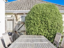 An outdoor area with a wooden table and chairs at Woodbury in Teignmouth