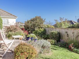 A garden with flowers and seating at Woodbury in Teignmouth
