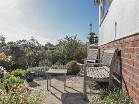 A garden with a table and benches at Woodbury in Teignmouth