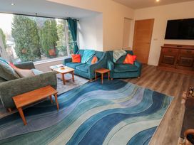 A living room with sofa, armchair and coffee table at Westerlodge Threlkeld near Keswick