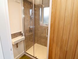 A bathroom with a shower and sink at Westerlodge Threlkeld near Keswick