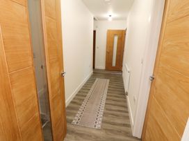 A hallway with doors and a rug at Westerlodge Threlkeld near Keswick