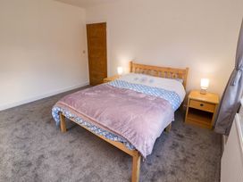 A bedroom with a bed and nightstands at Westerlodge Threlkeld near Keswick