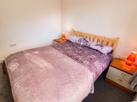 A bedroom with a bed and bedside lamps at Westerlodge Threlkeld near Keswick