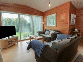 A living room with a sofa and coffee table at Woodlands View in Leek
