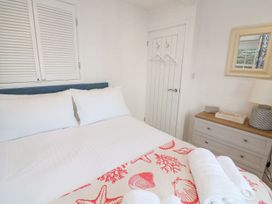 A bedroom with a bed and a bedside table at Quay cottage Salcombe