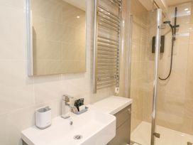 A bathroom with a sink and shower at Quay cottage Salcombe
