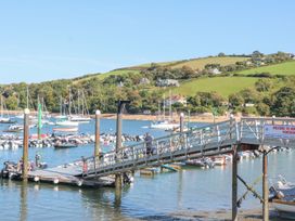 Boats at a marina with a pier and people at Quay cottage Salcombe