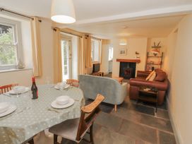 A dining room with a table and chairs at Rock Cottage in Milnthorpe