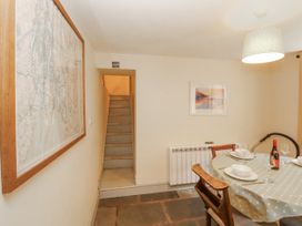 A dining room with a table set for dinner at Rock Cottage in Milnthorpe