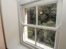 A window with a view of outdoor plants at Rock Cottage Milnthorpe