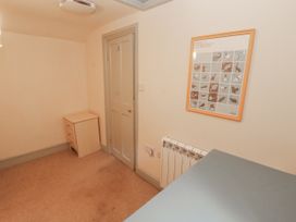 A room with a drawer unit and wall art at Rock Cottage in Milnthorpe