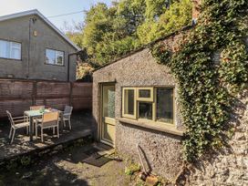 An outdoor area with a table and chairs at Rock Cottage in Milnthorpe