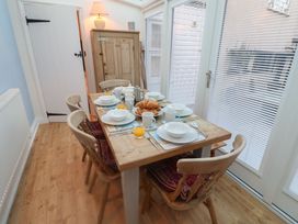 A dining room with a table set for breakfast at Nutshell in Aldeburgh