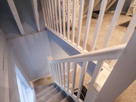 A staircase with a banister and decorative item in Nutshell, Aldeburgh