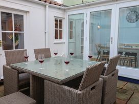 An outdoor dining area with a table and chairs at Nutshell in Aldeburgh