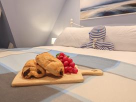 A bedroom with a bed and food on a tray at The Nutshell in Aldeburgh